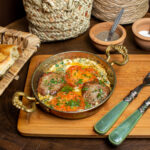 front-close-up-view-meal-eggs-with-red-tomatoes-meat-slices-along-with-cutlery-bread-slices
