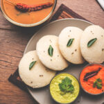 Idly sambar or Idli with Sambhar and green, red chutney. Popular South indian breakfast
